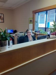 Snohomish chiropractic office has smiling receptionist.